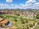 Aerial view of a house near a golf course with mountain views in the distance at 18851 N 69Th Ave, Glendale, AZ 85308