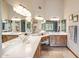 Spacious bathroom boasting a double sink vanity with a large framed mirror and wooden cabinets at 18851 N 69Th Ave, Glendale, AZ 85308