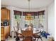 Charming breakfast nook with a Tiffany-style lamp and views of the green backyard with pool at 18851 N 69Th Ave, Glendale, AZ 85308