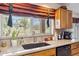 Bright kitchen featuring a garden view from above the sink, with potted plants and modern fixtures at 18851 N 69Th Ave, Glendale, AZ 85308
