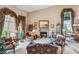 Expansive living room with fireplace, large windows, and elegant decor at 18851 N 69Th Ave, Glendale, AZ 85308