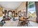 Open living area with dining table, soaring ceilings, large windows and abundant natural light at 18851 N 69Th Ave, Glendale, AZ 85308