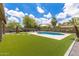 Spacious backyard with a pool, artificial turf, and desert landscaping at 2111 E Yellowstone Pl, Chandler, AZ 85249