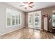 The light-filled bedroom features shutters, hardwood floors, and direct access to the backyard at 2111 E Yellowstone Pl, Chandler, AZ 85249