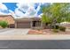 Charming home featuring a well-manicured lawn, a two-car garage, and tasteful desert landscaping at 2111 E Yellowstone Pl, Chandler, AZ 85249