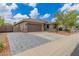 Beautiful home showcasing a two-car garage, desert landscaping, and charming brick driveway at 2111 E Yellowstone Pl, Chandler, AZ 85249