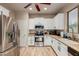Bright kitchen with stainless steel appliances, white cabinets, and tan countertops at 2111 E Yellowstone Pl, Chandler, AZ 85249