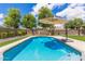 A refreshing backyard pool with lush green lawn and a relaxing lounge umbrella at 2111 E Yellowstone Pl, Chandler, AZ 85249
