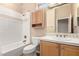 Clean bathroom features white tile, a vanity with cabinet, and a matching framed mirror at 22222 N Pedregosa Dr, Sun City West, AZ 85375