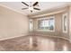 Bedroom with tile flooring, ceiling fan, and plantation shutters on the windows allowing natural light at 22222 N Pedregosa Dr, Sun City West, AZ 85375