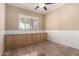 Room featuring tile flooring, ceiling fan and a built-in cabinet offering ample storage space at 22222 N Pedregosa Dr, Sun City West, AZ 85375