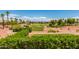 Picturesque golf course with lush green fairways, mature trees, and scenic pond at 22222 N Pedregosa Dr, Sun City West, AZ 85375