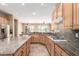 Open kitchen design with granite countertops, stainless steel appliances, and ample cabinet space at 22222 N Pedregosa Dr, Sun City West, AZ 85375