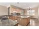 Beautiful kitchen with granite countertops, an island, and plenty of cabinet storage space at 22222 N Pedregosa Dr, Sun City West, AZ 85375