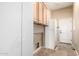 Featuring ample storage space, the laundry room boasts both upper and lower cabinets and modern appliances at 22222 N Pedregosa Dr, Sun City West, AZ 85375