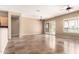 Spacious living room featuring tile flooring, ceiling fans, and sliding door access to the backyard at 22222 N Pedregosa Dr, Sun City West, AZ 85375
