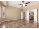 Spacious main bedroom with a ceiling fan, tile flooring and a door to the main bathroom at 22222 N Pedregosa Dr, Sun City West, AZ 85375