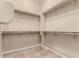 Walk-in closet with installed shelving for organizing personal items and clothing at 22222 N Pedregosa Dr, Sun City West, AZ 85375