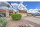 Charming townhome featuring desert landscaping, attached garage, and red tile roof at 2505 E Desert Cactus St, Phoenix, AZ 85032