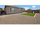 The backyard features gravel landscaping, with a turf area, and a playground at 25974 W Horsham Dr, Buckeye, AZ 85396