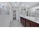 Well-lit bathroom with dual sinks, a walk-in shower, and a spacious vanity, offering ample storage at 25974 W Horsham Dr, Buckeye, AZ 85396