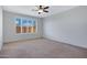 A spacious bedroom features neutral colored carpet, shuttered windows, and ample natural light at 25974 W Horsham Dr, Buckeye, AZ 85396