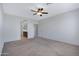 Large bedroom boasts a ceiling fan, an ensuite bathroom and a large window for natural light at 25974 W Horsham Dr, Buckeye, AZ 85396