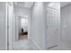 Hallway leading to the bedroom, with tile floors and neutral gray paint at 25974 W Horsham Dr, Buckeye, AZ 85396