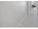 Bright hallway featuring tile floors leading to a spacious, light-filled living area at 25974 W Horsham Dr, Buckeye, AZ 85396