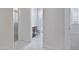 Hallway that has gray tile flooring leading to other rooms with neutral-colored carpet at 25974 W Horsham Dr, Buckeye, AZ 85396