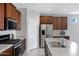 Gourmet kitchen equipped with stainless steel appliances and rich, dark wood cabinetry at 25974 W Horsham Dr, Buckeye, AZ 85396