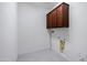 Laundry room with overhead storage and tile floors at 25974 W Horsham Dr, Buckeye, AZ 85396