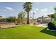 A well-manicured backyard featuring artificial turf, a hot tub, and outdoor furniture, perfect for entertaining at 2611 E Cheryl Dr, Phoenix, AZ 85028