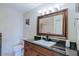 Bathroom featuring granite counters, wood cabinetry, and tile floors at 2611 E Cheryl Dr, Phoenix, AZ 85028