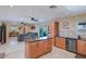 Open kitchen with island, stainless steel appliances, and seamless flow to living area at 2611 E Cheryl Dr, Phoenix, AZ 85028