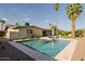 Backyard featuring a beautiful pool, lush landscaping, and inviting patio seating on a sunny day at 2611 E Cheryl Dr, Phoenix, AZ 85028