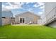 Spacious backyard featuring artificial turf, patio, privacy fence, and outdoor lounge chairs at 2731 E Windsor Ave, Phoenix, AZ 85008