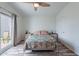 Bright bedroom features wood-look flooring and backyard access through sliding glass doors at 2731 E Windsor Ave, Phoenix, AZ 85008