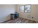 Cozy bedroom features a functional desk area with a window view, complemented by wood-look flooring at 2731 E Windsor Ave, Phoenix, AZ 85008
