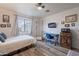 Bright bedroom with comfortable bed, functional desk area, and mounted TV for relaxation at 2731 E Windsor Ave, Phoenix, AZ 85008