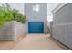 Detached garage with blue door and blooming bougainvillea at 2731 E Windsor Ave, Phoenix, AZ 85008