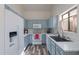 Bright kitchen with blue cabinets, white appliances, white countertop, and wood-look floors at 2731 E Windsor Ave, Phoenix, AZ 85008
