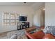 Bright living room features vaulted ceilings, wood-look floors, and a large window for natural light at 2731 E Windsor Ave, Phoenix, AZ 85008