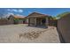 The backyard features gravel landscaping, a patio, offering low-maintenance living and desert beauty at 29058 N Cactus Cir, San Tan Valley, AZ 85143