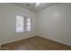 A cozy bedroom showcases hardwood floors and a large window offering plenty of natural light at 29058 N Cactus Cir, San Tan Valley, AZ 85143