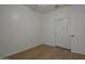 A well-lit bedroom with hardwood floors features a closet with double doors for storage and organization at 29058 N Cactus Cir, San Tan Valley, AZ 85143