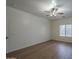 A spacious bedroom featuring hard surface floors, ceiling fan with light and a window at 29058 N Cactus Cir, San Tan Valley, AZ 85143