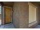 Covered front porch featuring a wood door with a digital keypad and textured walls at 29058 N Cactus Cir, San Tan Valley, AZ 85143