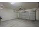 An empty two-car garage showcasing a working garage door and plenty of room for parking and storage at 29058 N Cactus Cir, San Tan Valley, AZ 85143