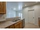 Kitchen sink with stainless appliances and view to back patio at 29058 N Cactus Cir, San Tan Valley, AZ 85143
